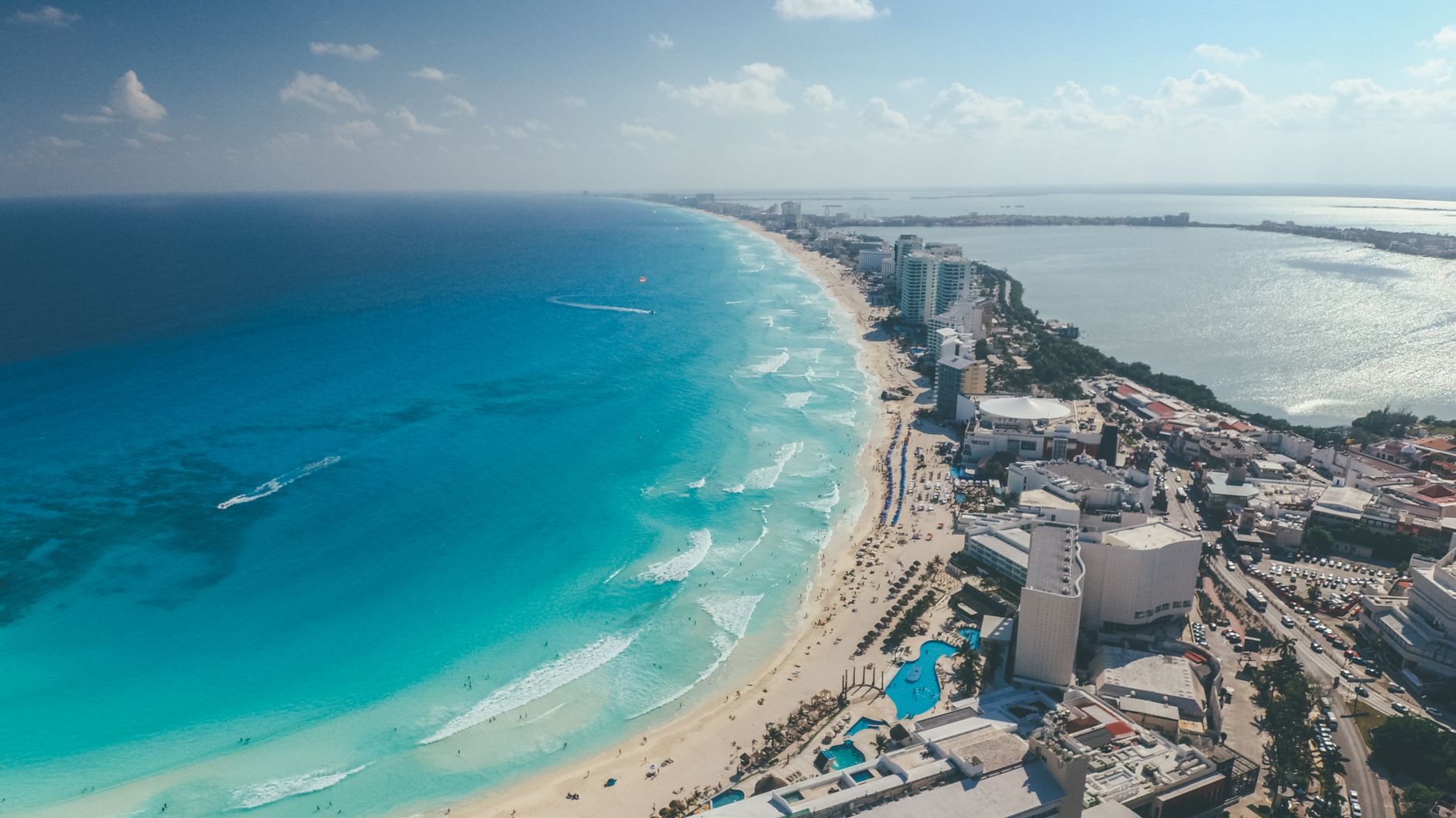 Breathtaking aerial photograph capturing Cancun's clear blue waters and vibrant cityscape.