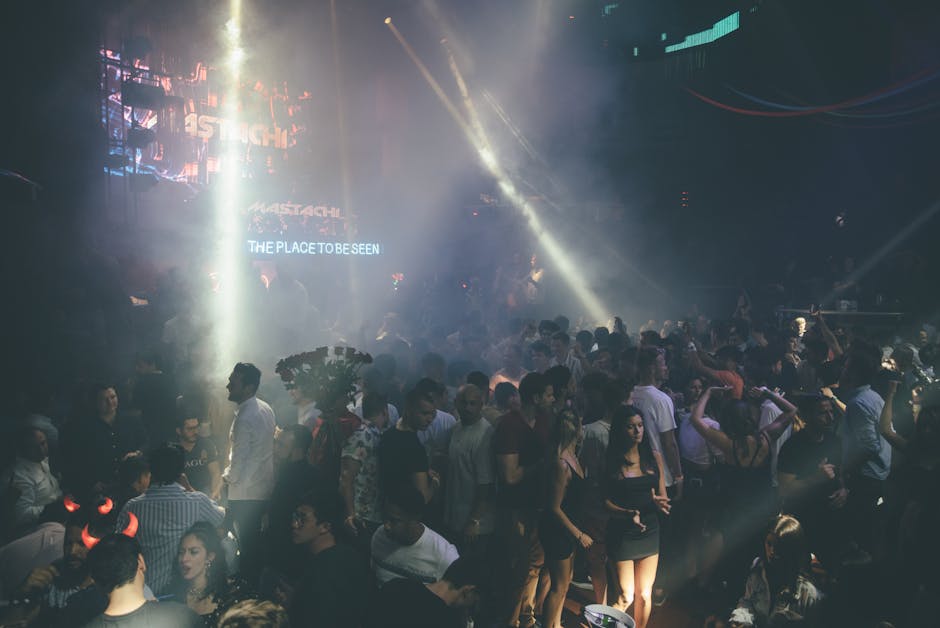 Exciting nightclub scene with a dancing crowd, vibrant lights, and music atmosphere.