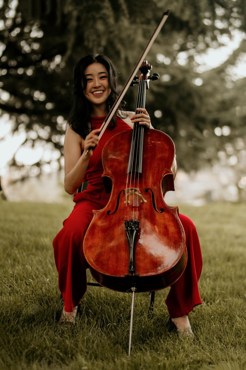 Woman joyfully playing a cello, depicting musical passion