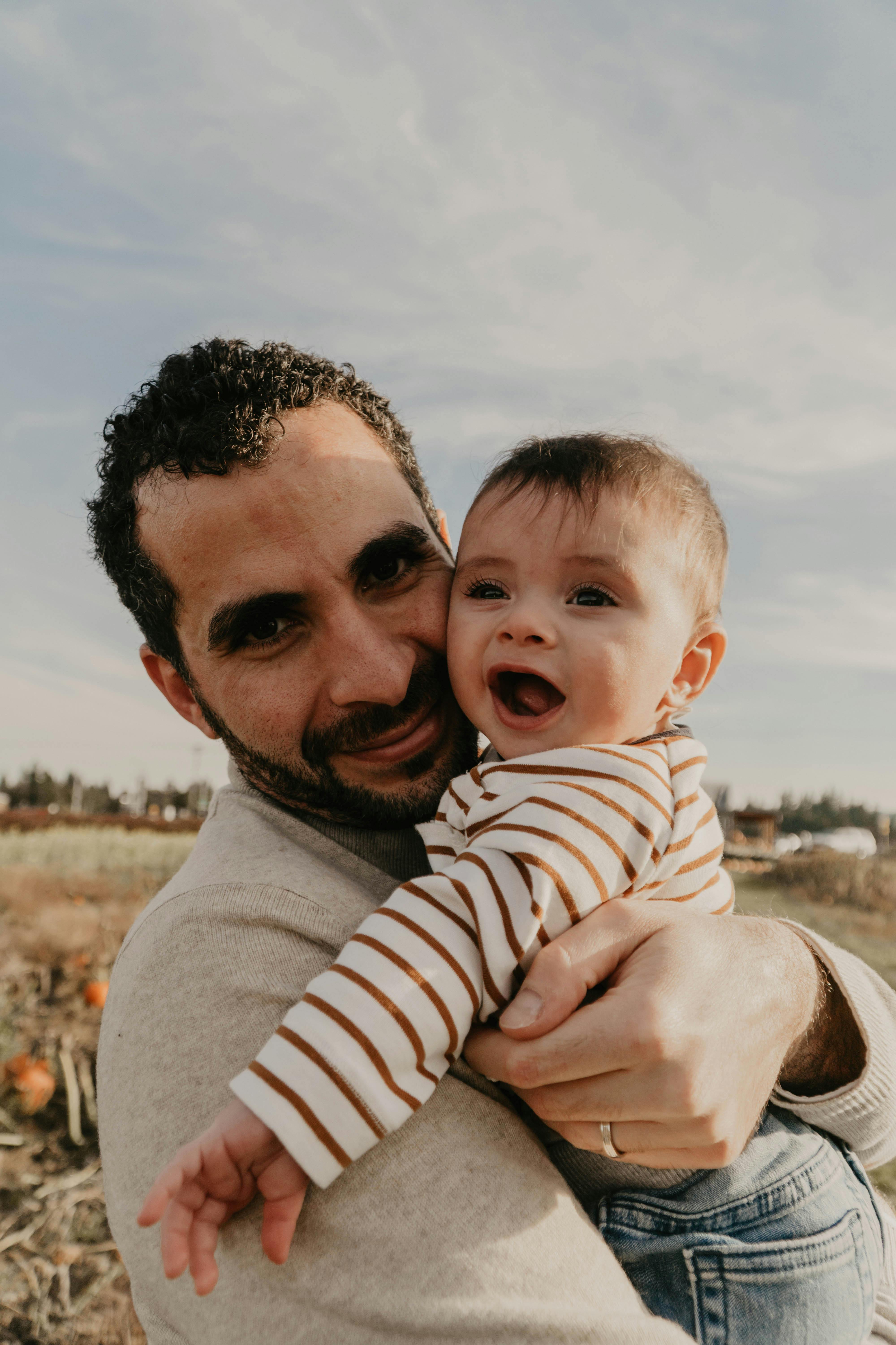 Happy father and baby son enjoying a sunny day outdoors in Portland.