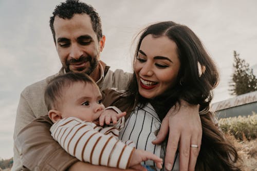 Free A Family Smiling at the Camera Stock Photo