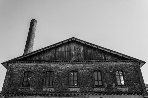 Grayscale Photo of a Brick Building