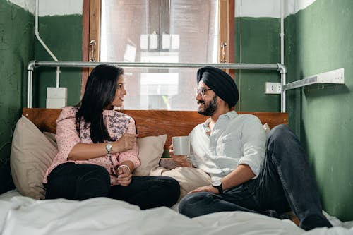 Cheerful couple resting on bed together