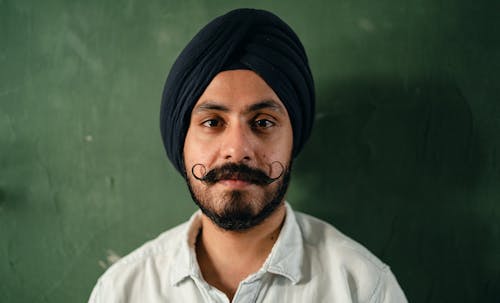 Positive man in traditional turban with mustache