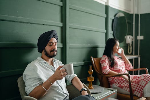 Couple relaxing indoors with coffee and conversation, enjoying peaceful togetherness.