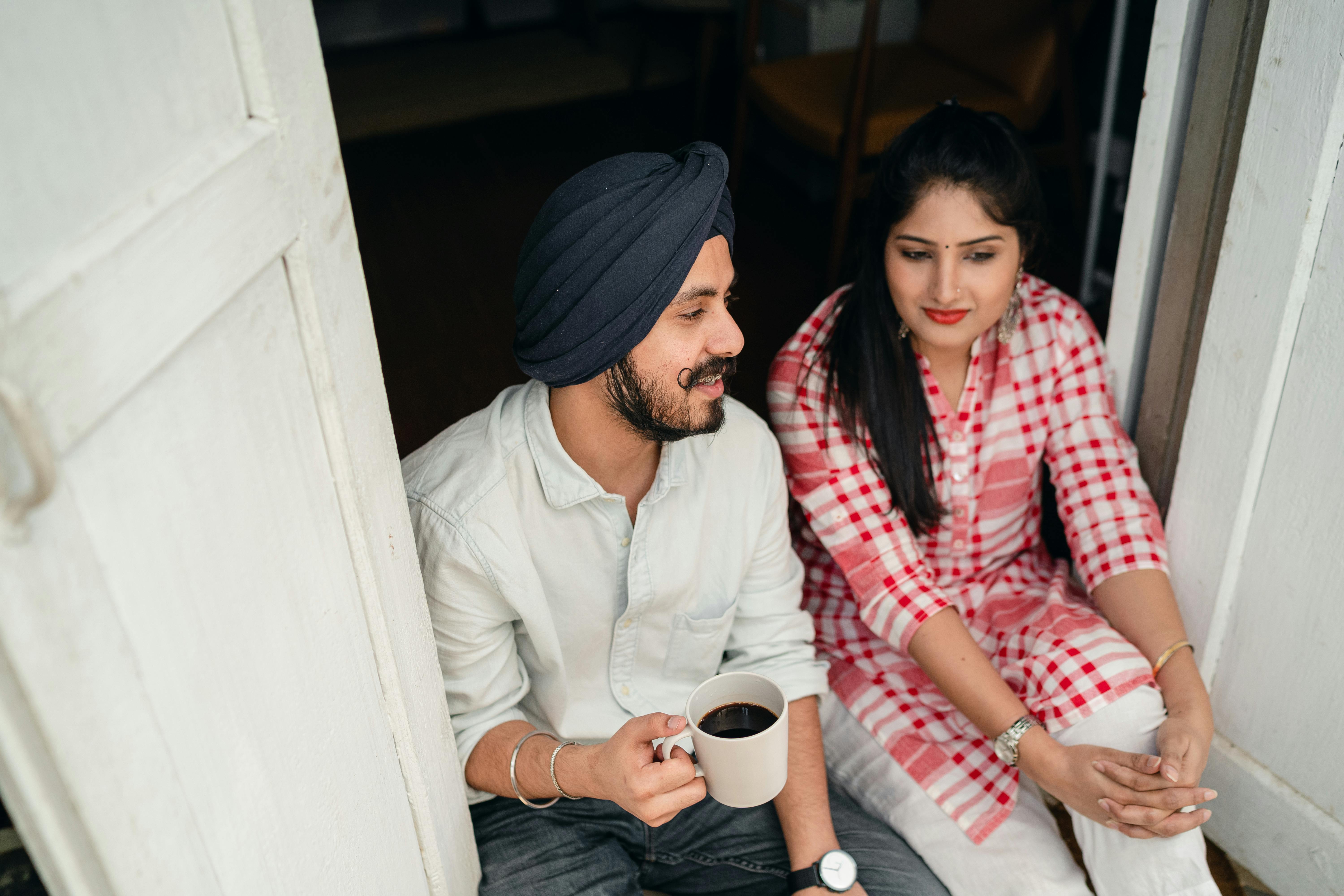 young married couple communicating on threshold of house