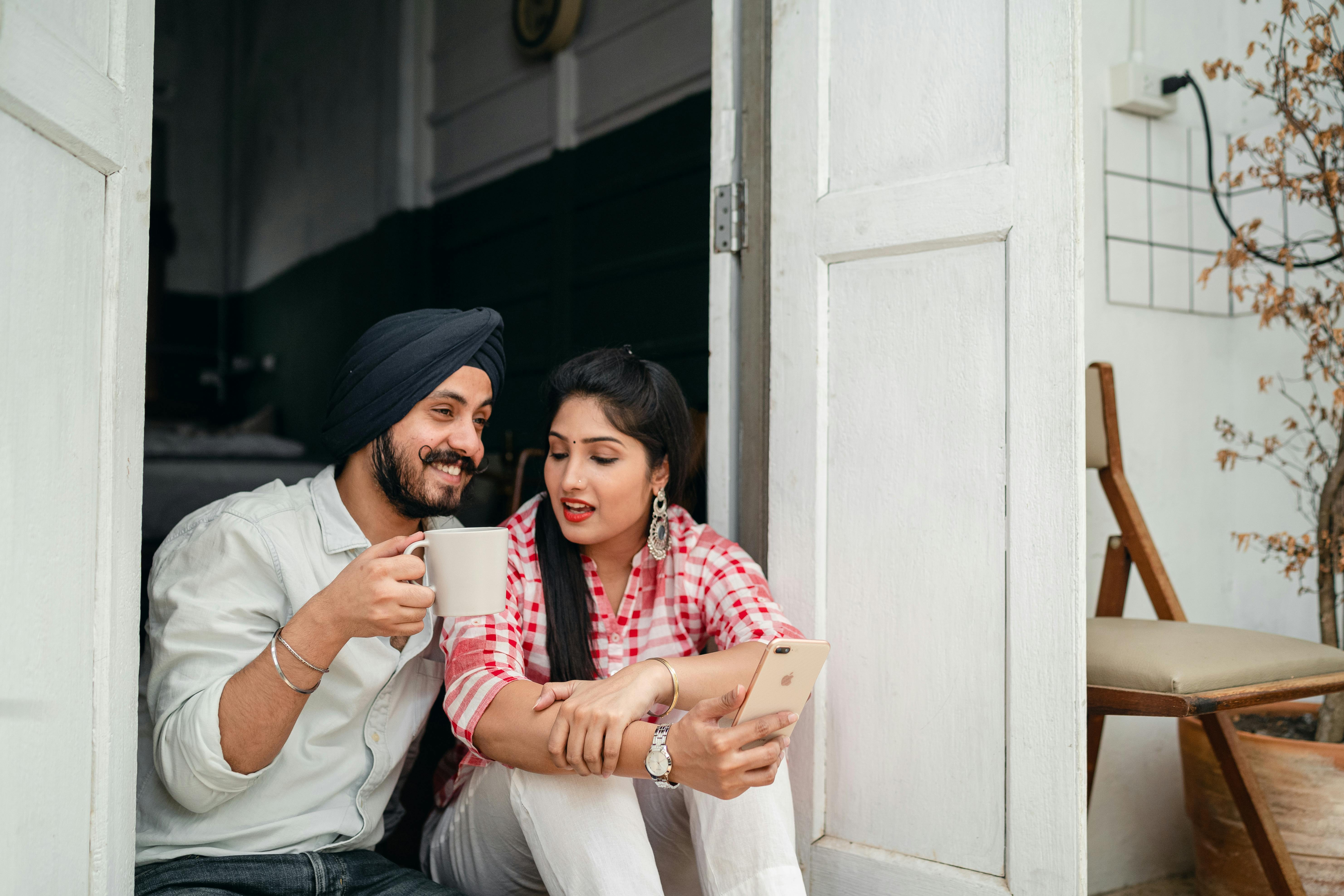 young couple chatting while sitting in doorway of veranda