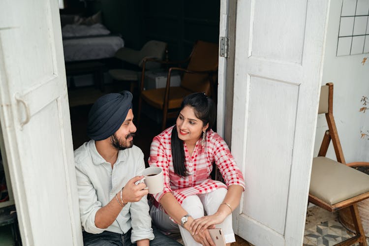 Happy Couple Talking On Veranda In Morning