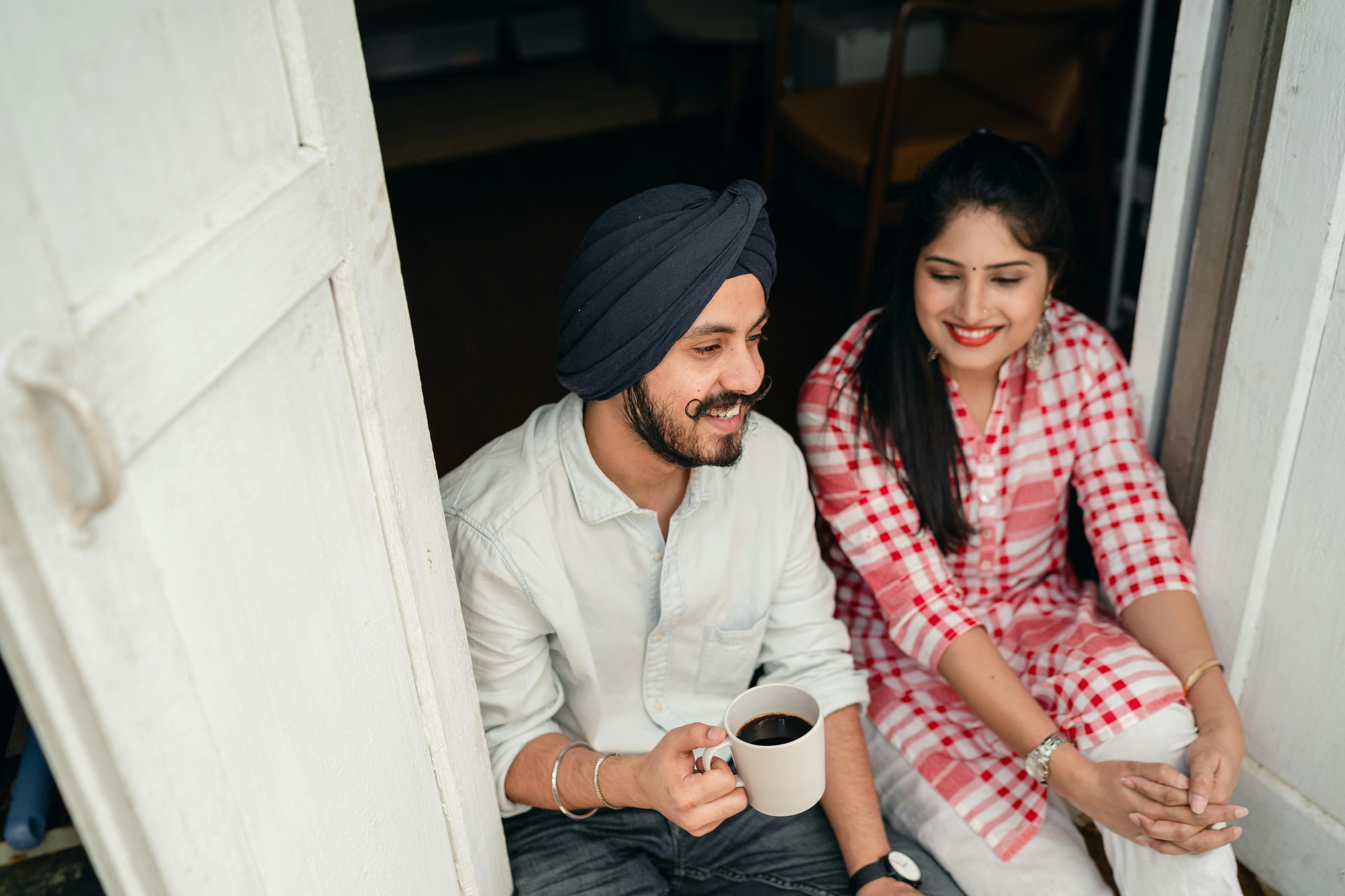 cheerful couple chatting on doorstep