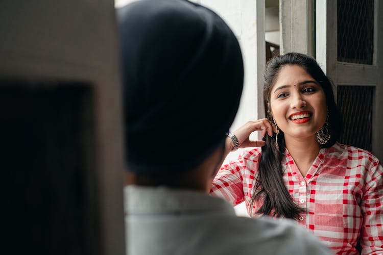 Young Lady Listening To Man With Interest And Smiling