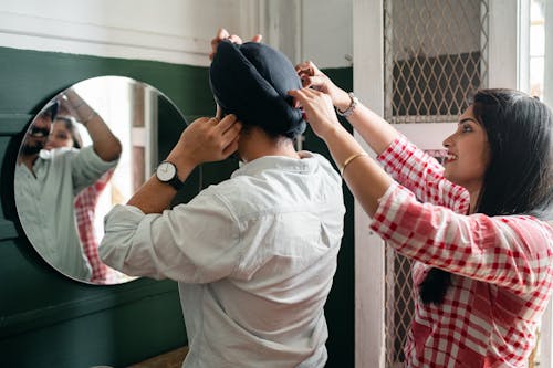 Young Indian married couple against mirror