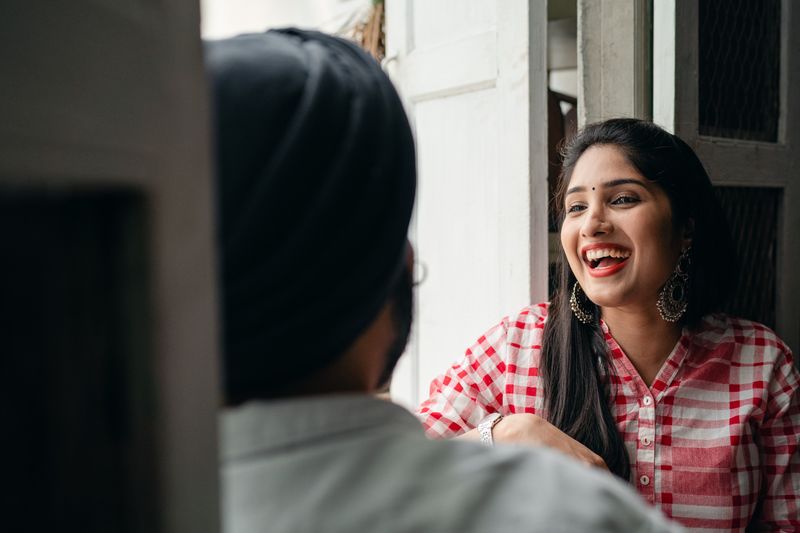 Indian married couple sharing a relaxed moment at home; illustrative stock photograph