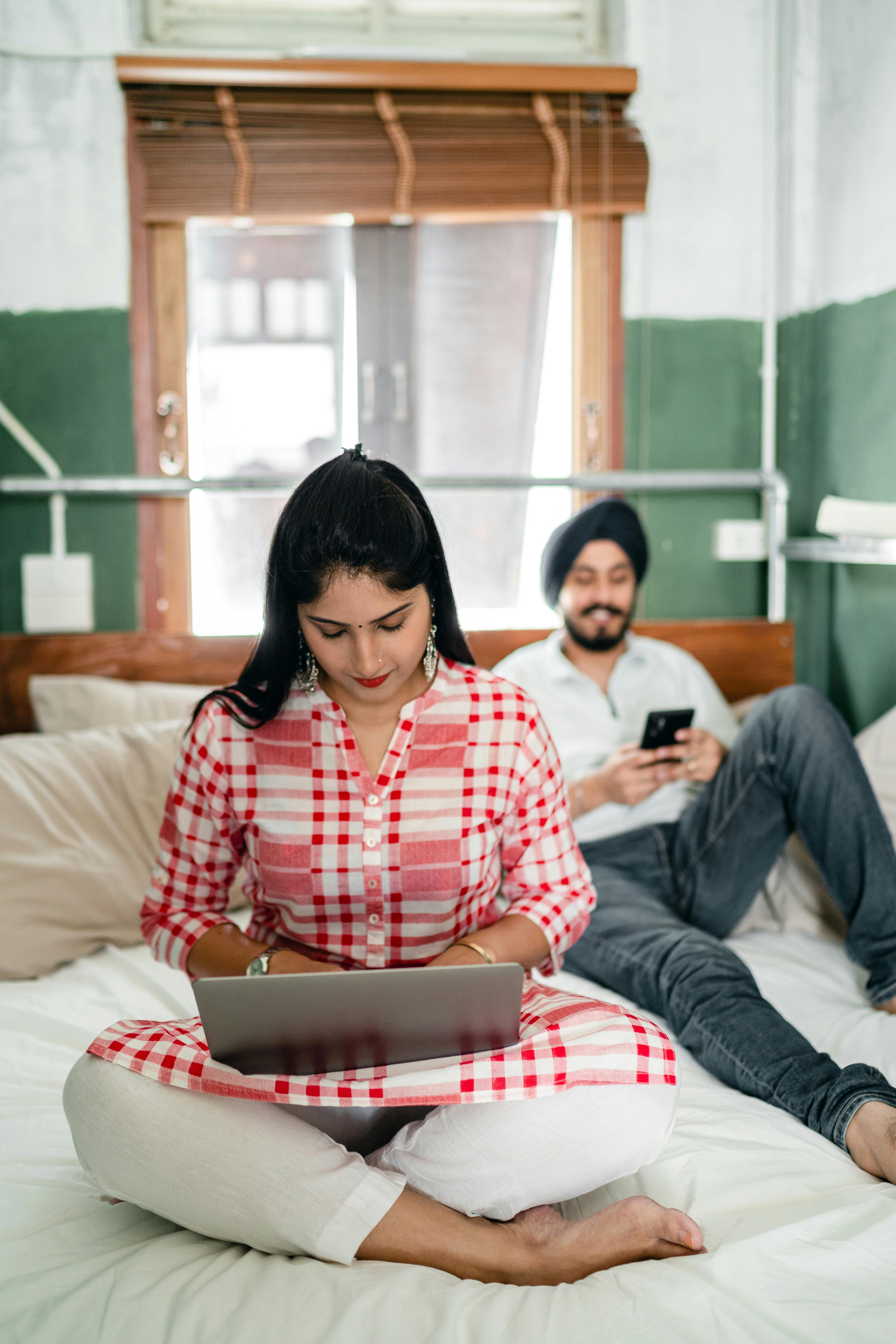 Happy Indian Couple Resting In Cozy Bedroom Free Sto