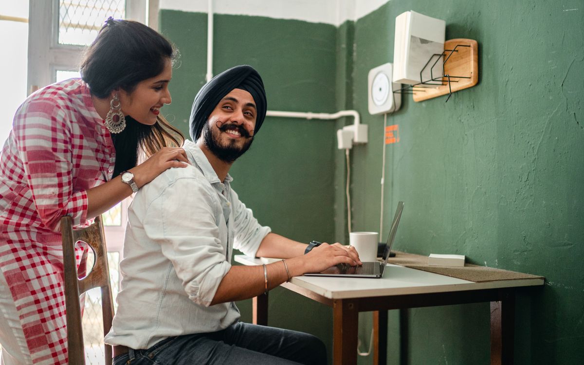 Indian professional working on a laptop at home