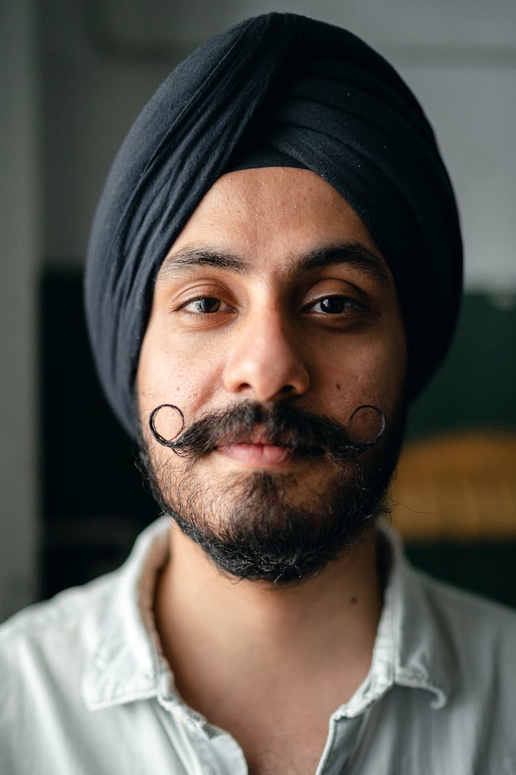 Positive Bearded Young Indian Guy In Turban