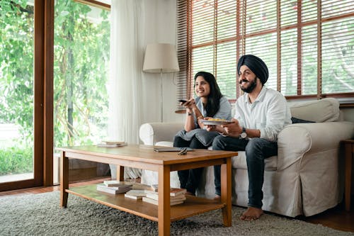 Positive married couple spending time together and watching movie