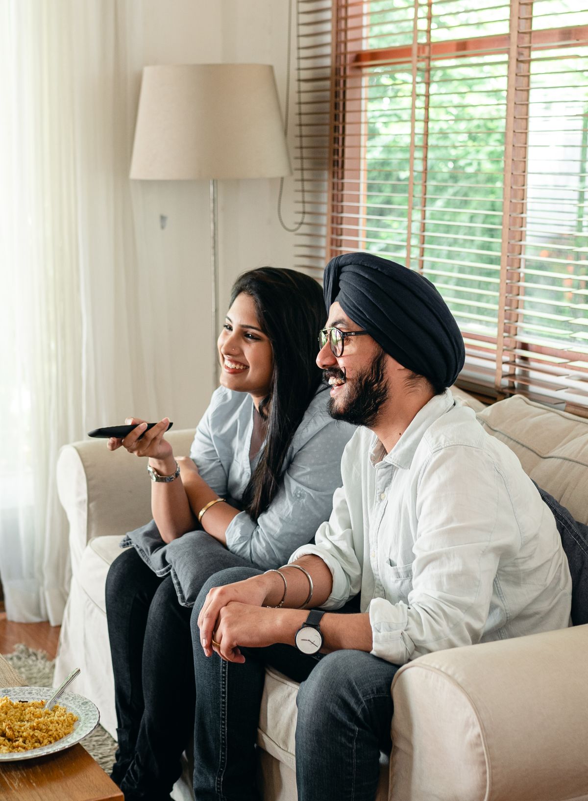 Couple watching television with a remote control