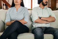 A couple with crossed arms showing quiet tension