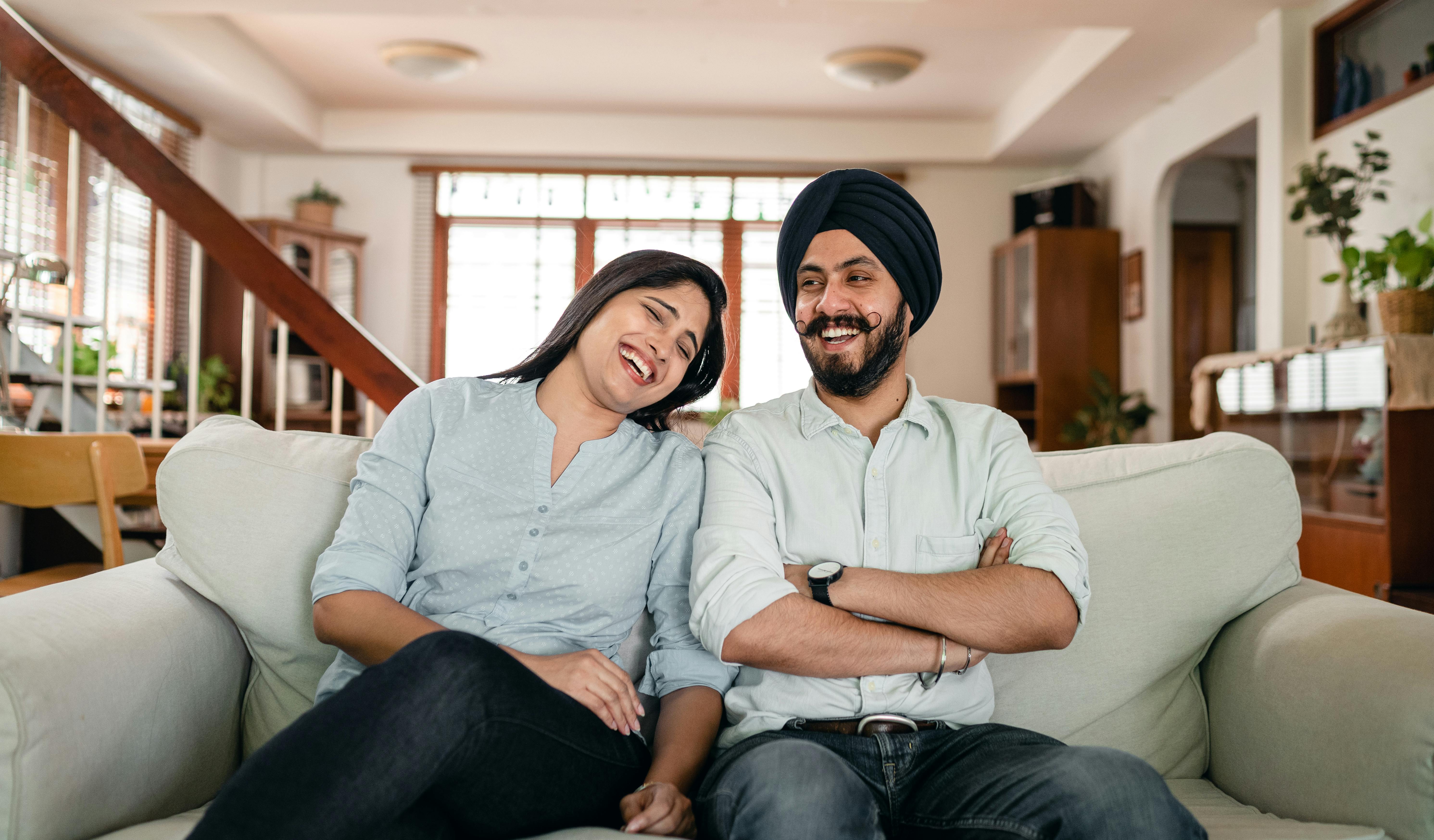 cheerful young indian couple joking while spending time together at home