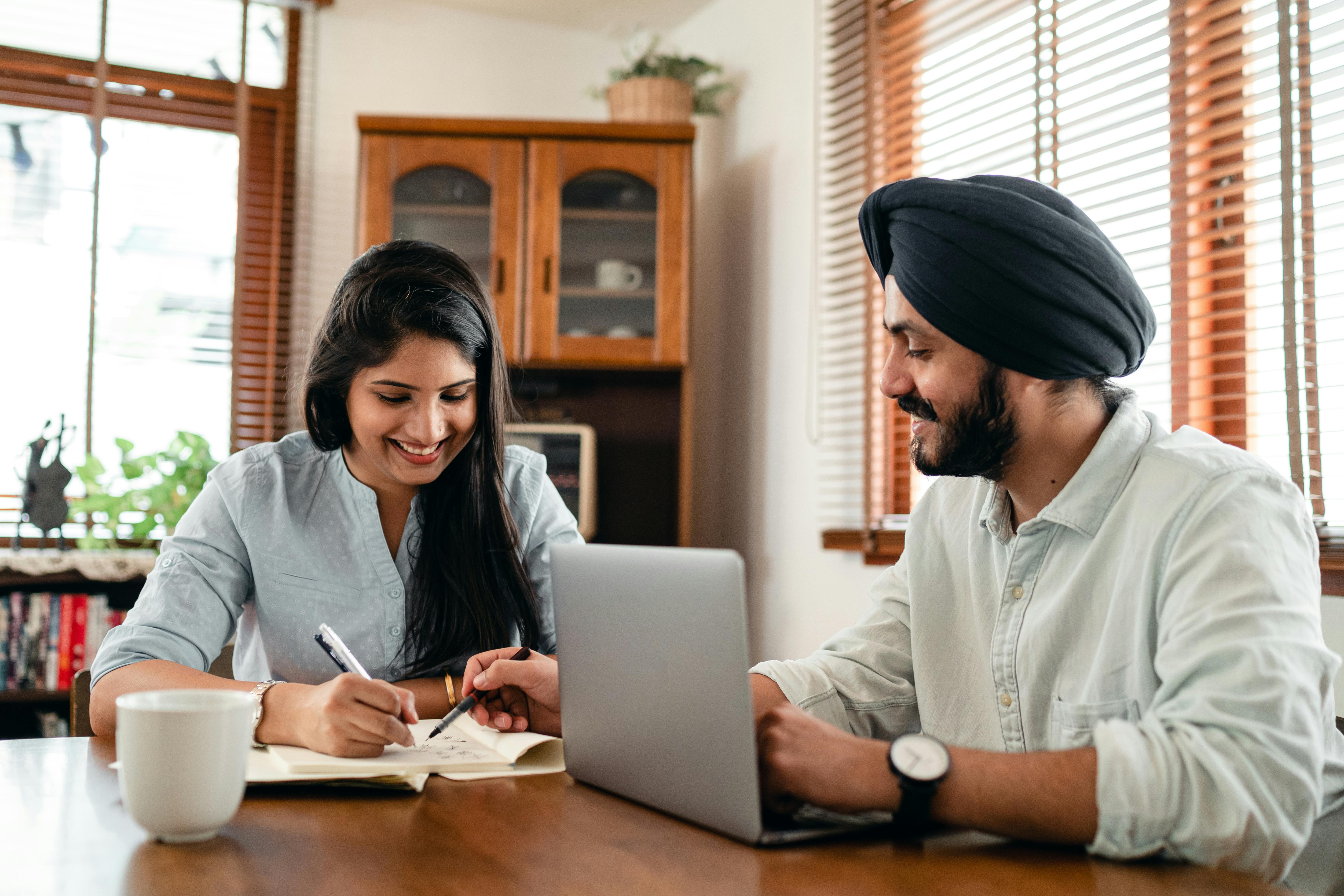 cheerful couple discussing project in living room