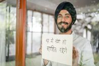 Content Indian guy showing paper with Hindi inscription