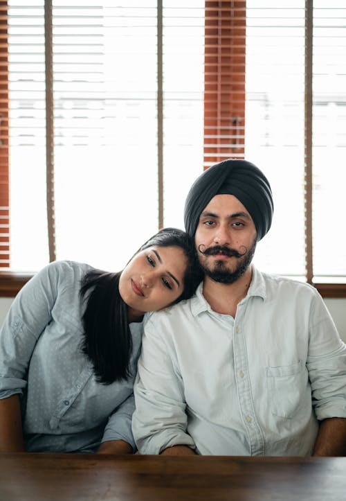 Romantic young Indian couple snuggling during date