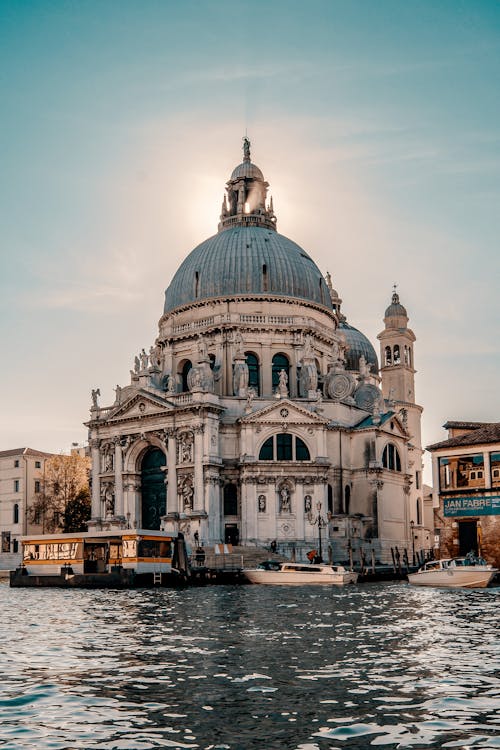 Aged stone basilica facade near river in Venice