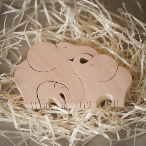 Free Wooden Carvings of an Elephant Family Stock Photo
