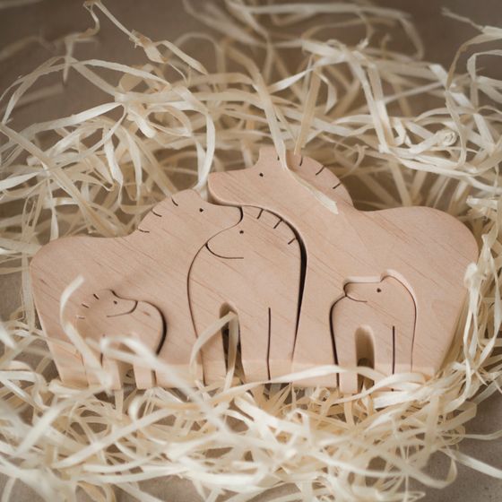 Wooden animal puzzle set nested in paper straw — photo by Jul Chi on Pexels