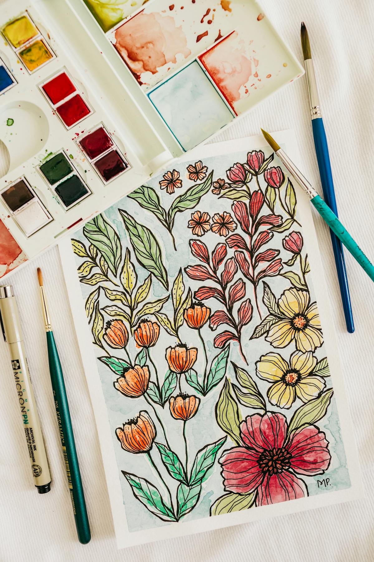 water color drawing of flowers and leaves in vibrant colors, red yellow and green.