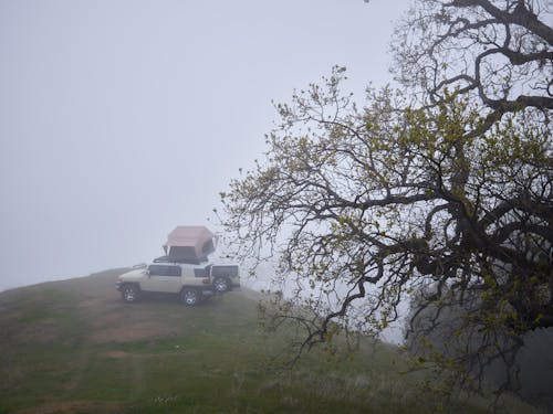 Free A Car with a Rooftop Tent on a Foggy Day Stock Photo