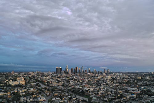 An Aerial Shot of a City under a Cloudy Sky