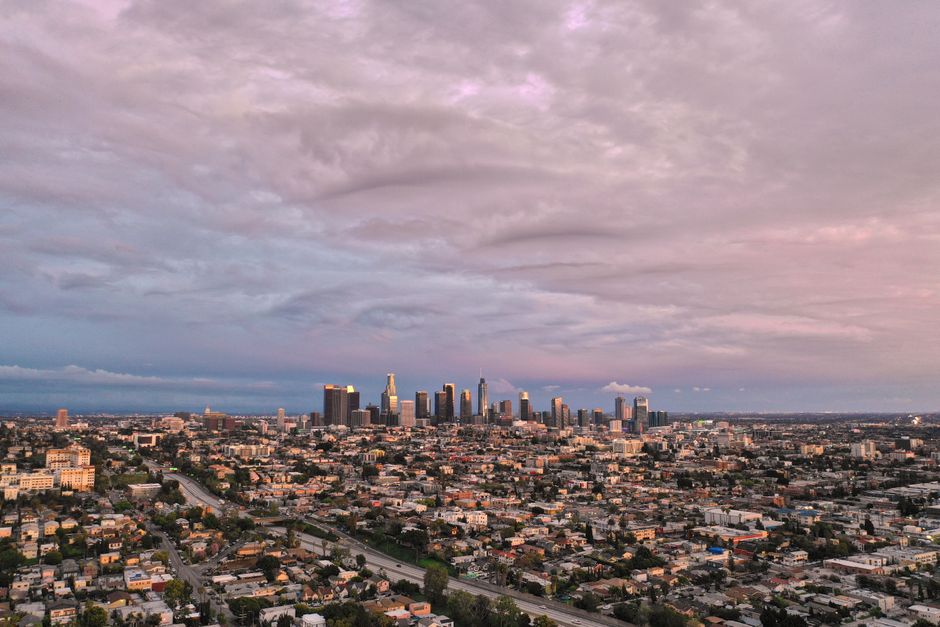 Incredible Private Helicopter Tour of Rancho Palos Verdes, Los Angeles, and Long Beach Review Review 2026 - Stunning aerial view of Los Angeles' skyline with cloudy skies at dusk, showcasing urban beauty.