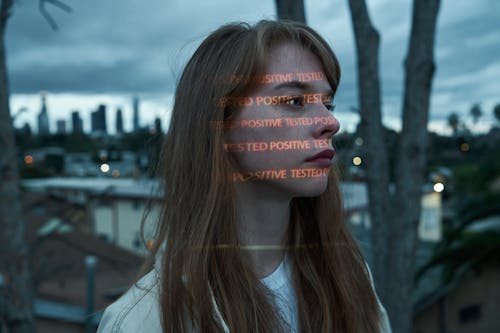 Concentrated woman on rooftop against night city