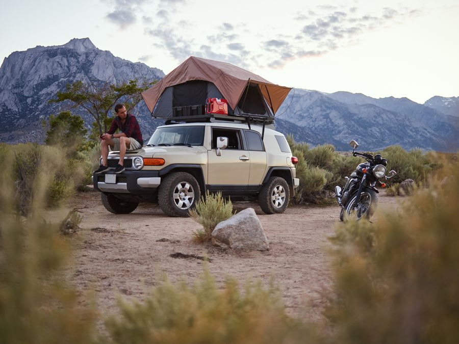 Illustrative hardshell rooftop tent camping scene