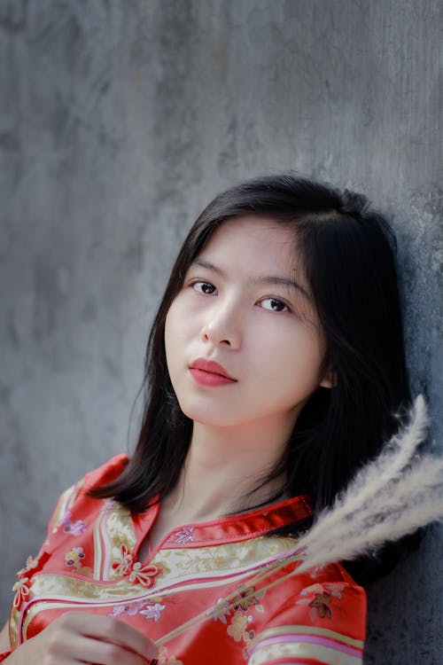 Young ethnic woman with plant branches