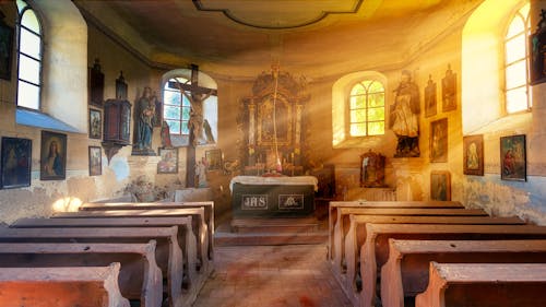 Free Interior of old catholic church with bright rays of sun Stock Photo