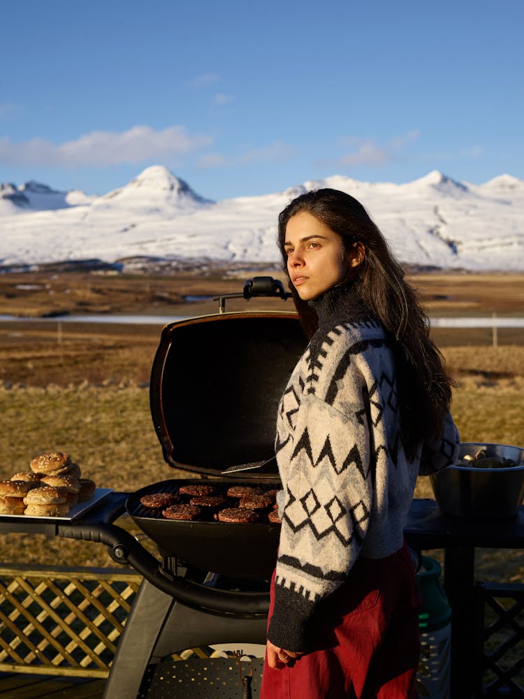 Young Woman With Grill In Countryside