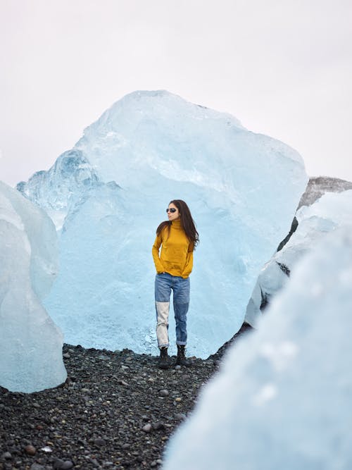 Female tourist standing among ice blocks