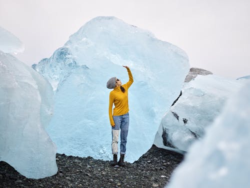 Woman admiring view of gigantic ice chunks