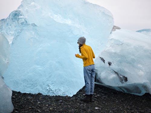 Female traveler viewing huge ice chunk