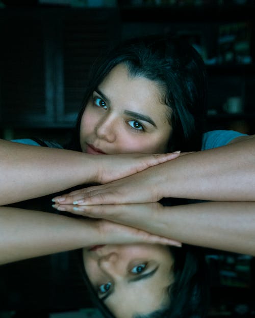 Free Photo of a Beautiful Woman Next to Her Reflection Stock Photo