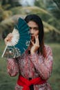 A Woman Holding a Hand Fan