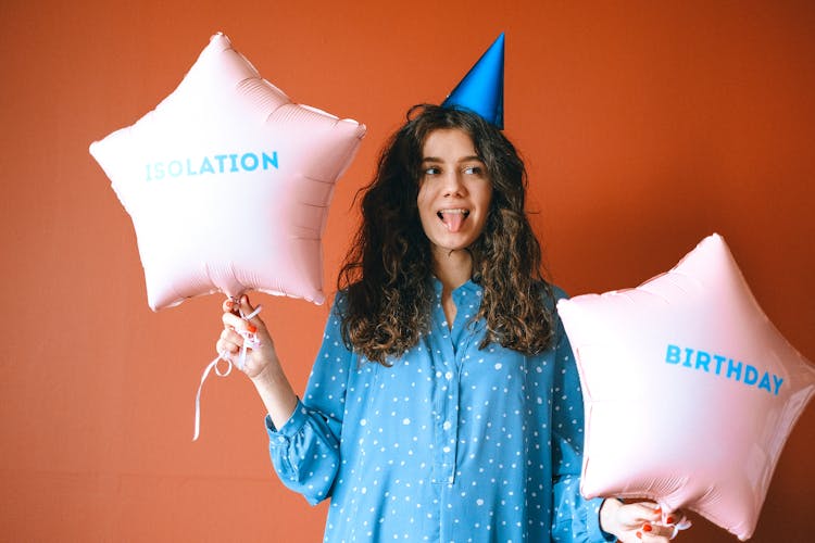 A Birthday Celebrant Holding Star Shaped Balloons