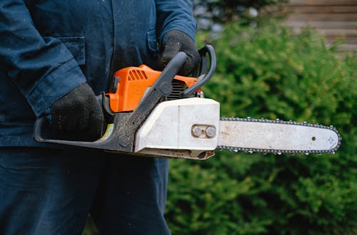 A Person Holding a Chainsaw Tool