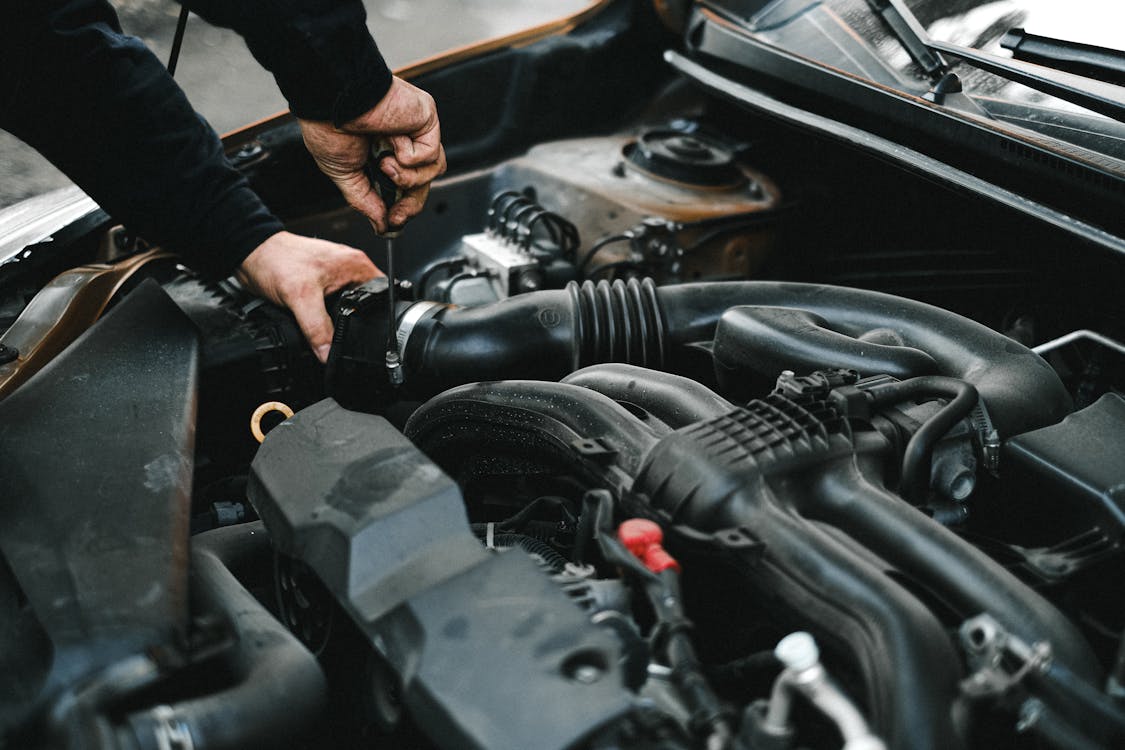 Person in Black Long Sleeve Shirt Holding Black Car Steering Wheel