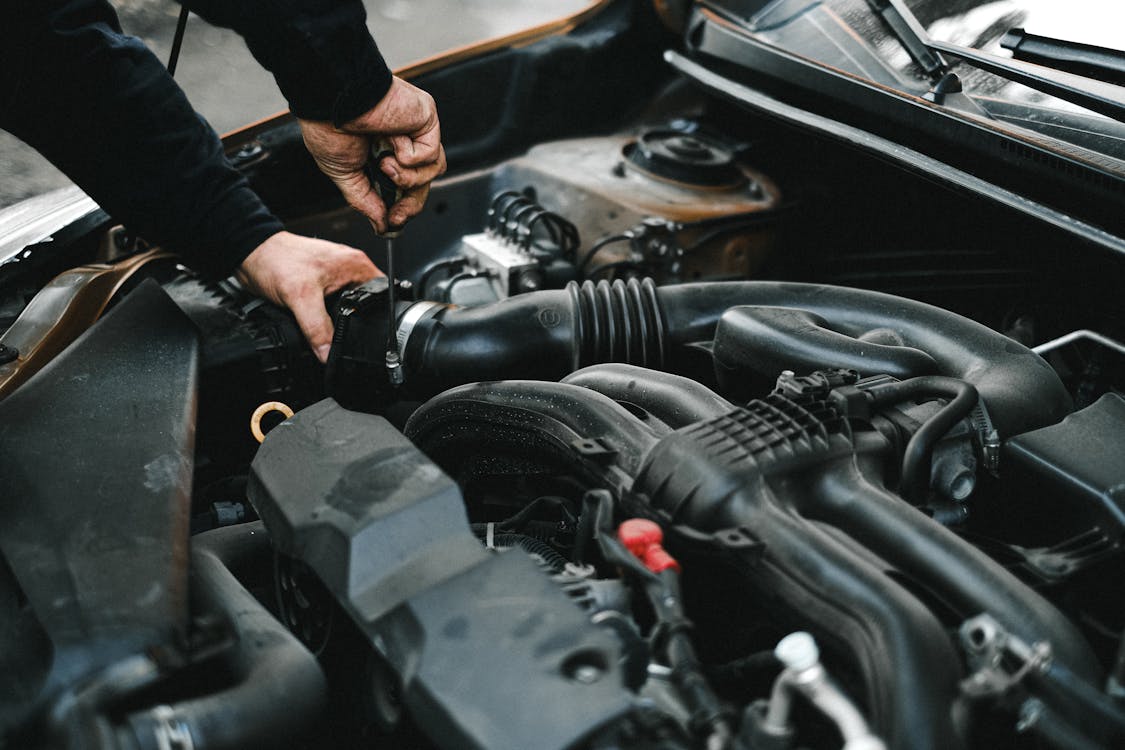 Free An Auto Mechanic Checking the Engine of a Car Stock Photo