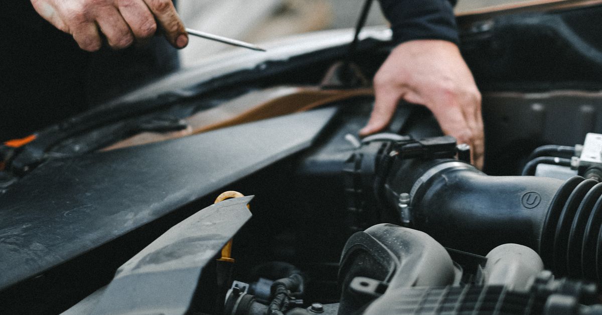 Car Getting Repaired Person in Black Long Sleeves Repairing the Car Engine · Free Stock Photo