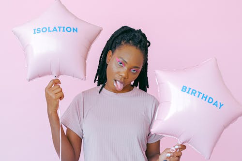 A Woman Holding a Star Shaped Balloons