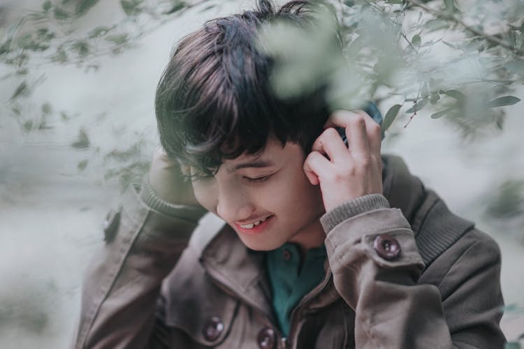 A Young Man Listening To Music Using Headphones